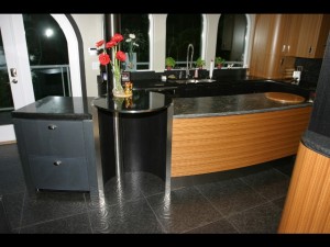 the sleek curved island with the stainless steel post/ electrical chase